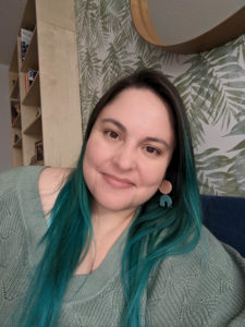 A close-up self-portrai of myself in my office. I'm smiling at the camera.